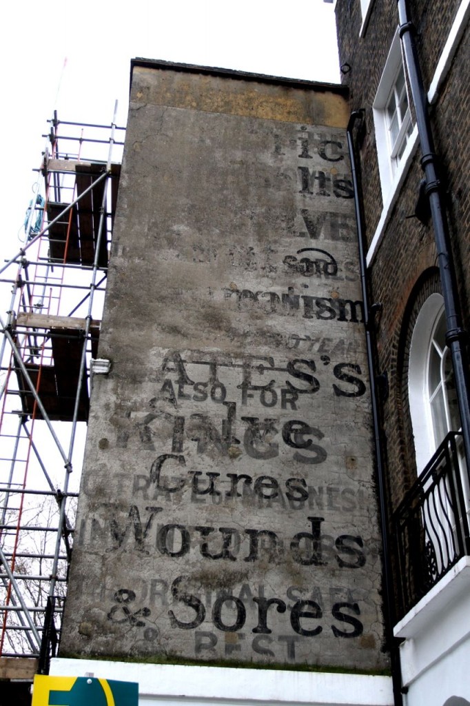 Old advertisements on a wall, corner of Regent's Square / Sidmouth Street, London (Photo:Tim Jones)