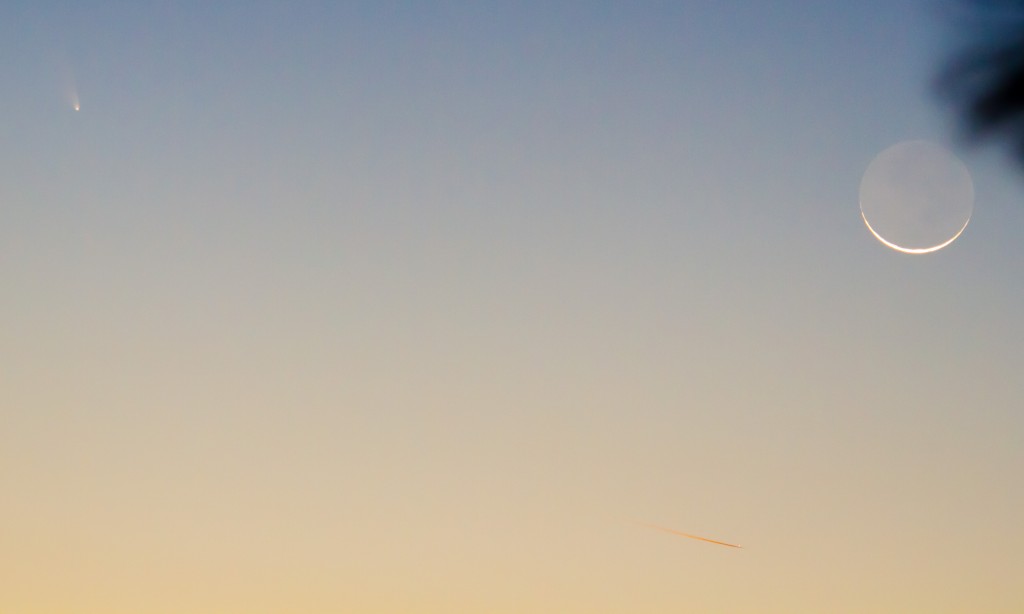 Comet, Moon, and aircraft with contrail illuminated by sun (below horizon)